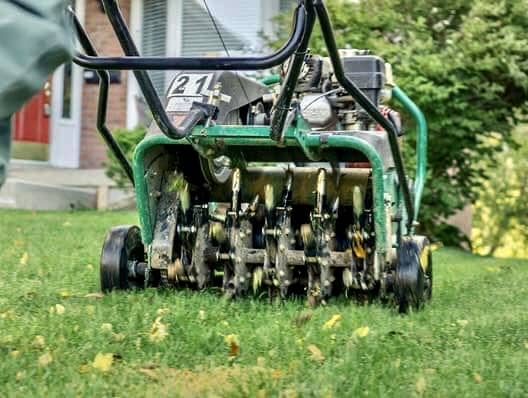 Lawn aeration machine running residential lawn